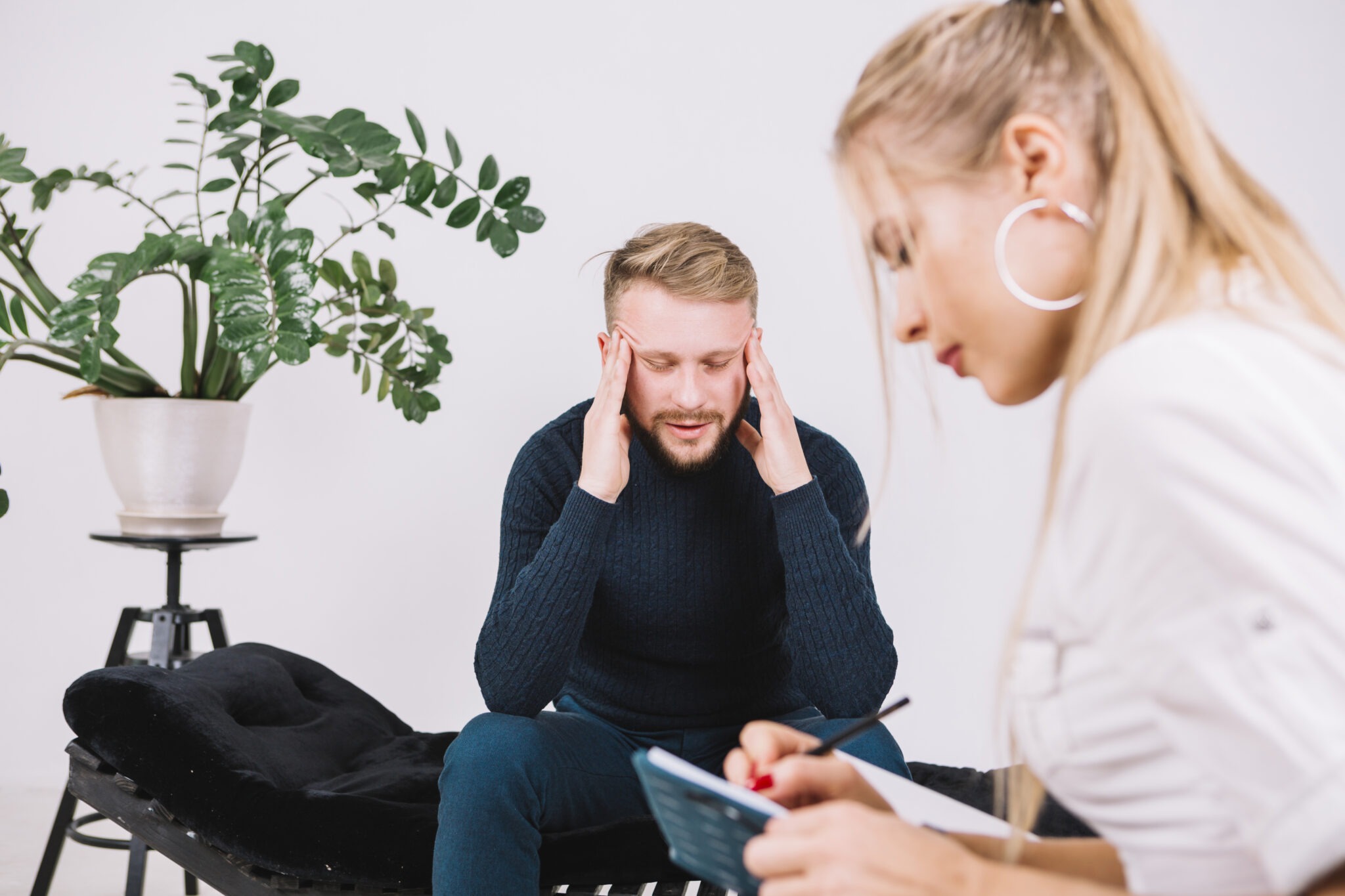 young-female-psychologist-is-writing-down-her-thoughts-about-depressed-patient